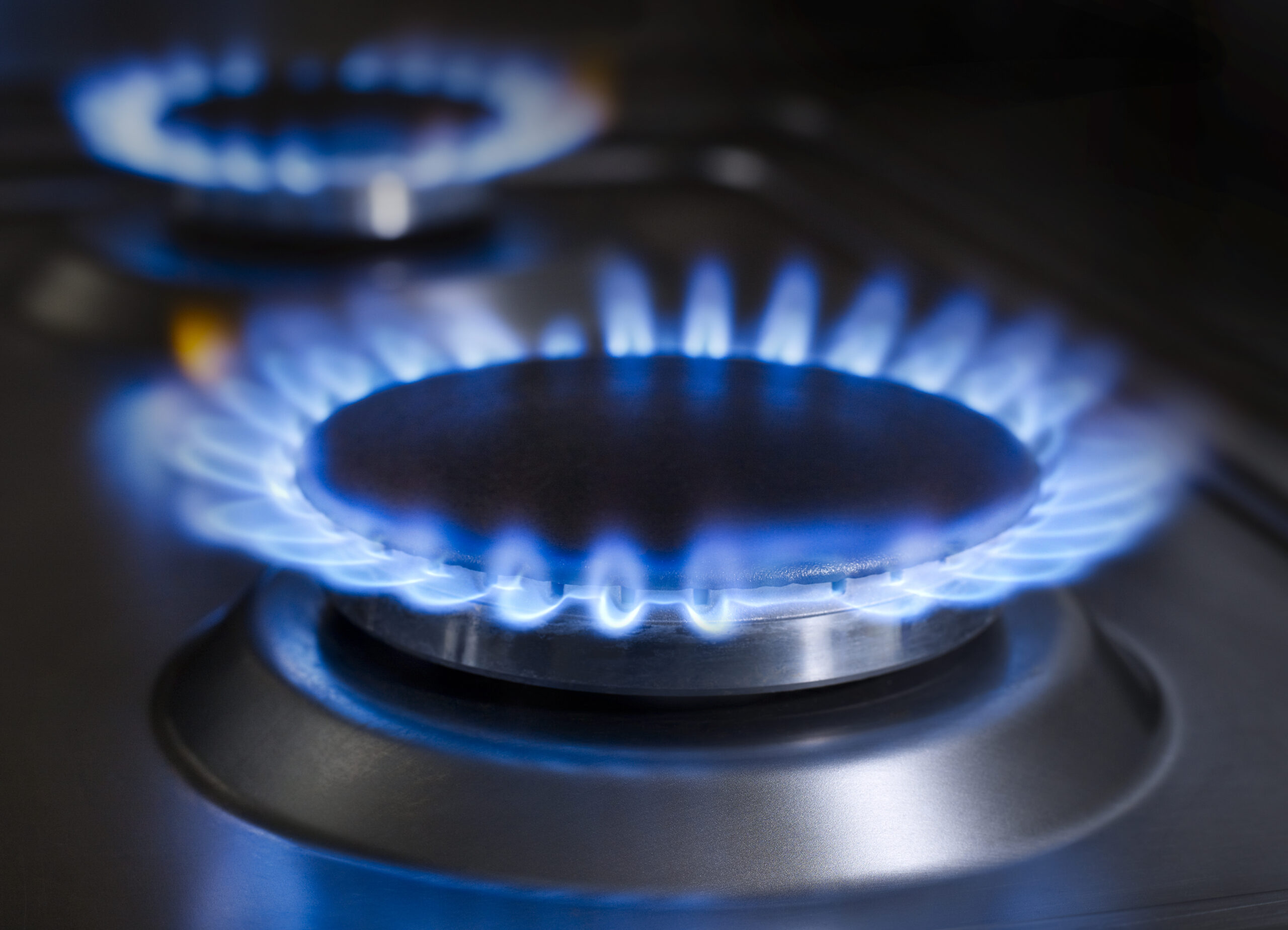 Blue flames from a kitchen gas range.
